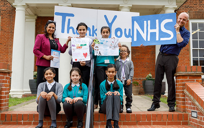 Primary school pupils holding 'Thank you NHS' sign